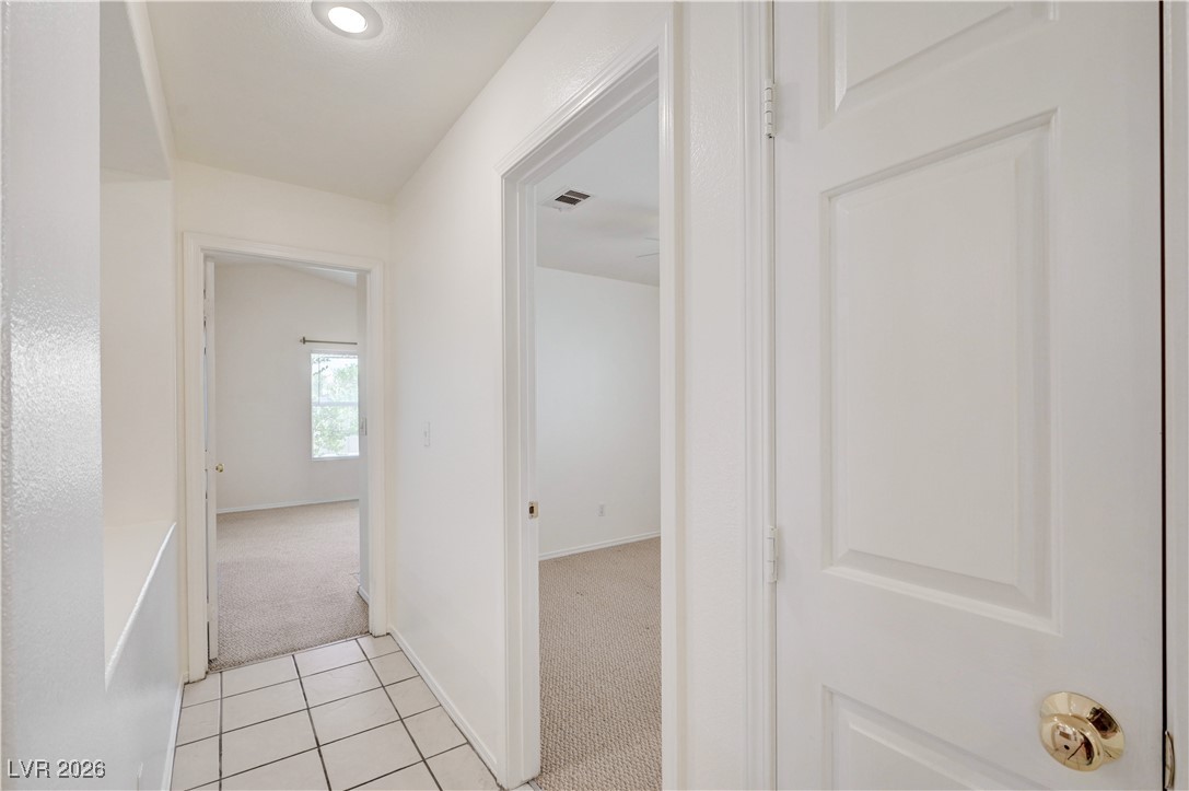 9929 Princess Cut Street Las Vegas, NV 89183 - Photo 25 of 52 Hall with light colored carpet and light tile patterned flooring