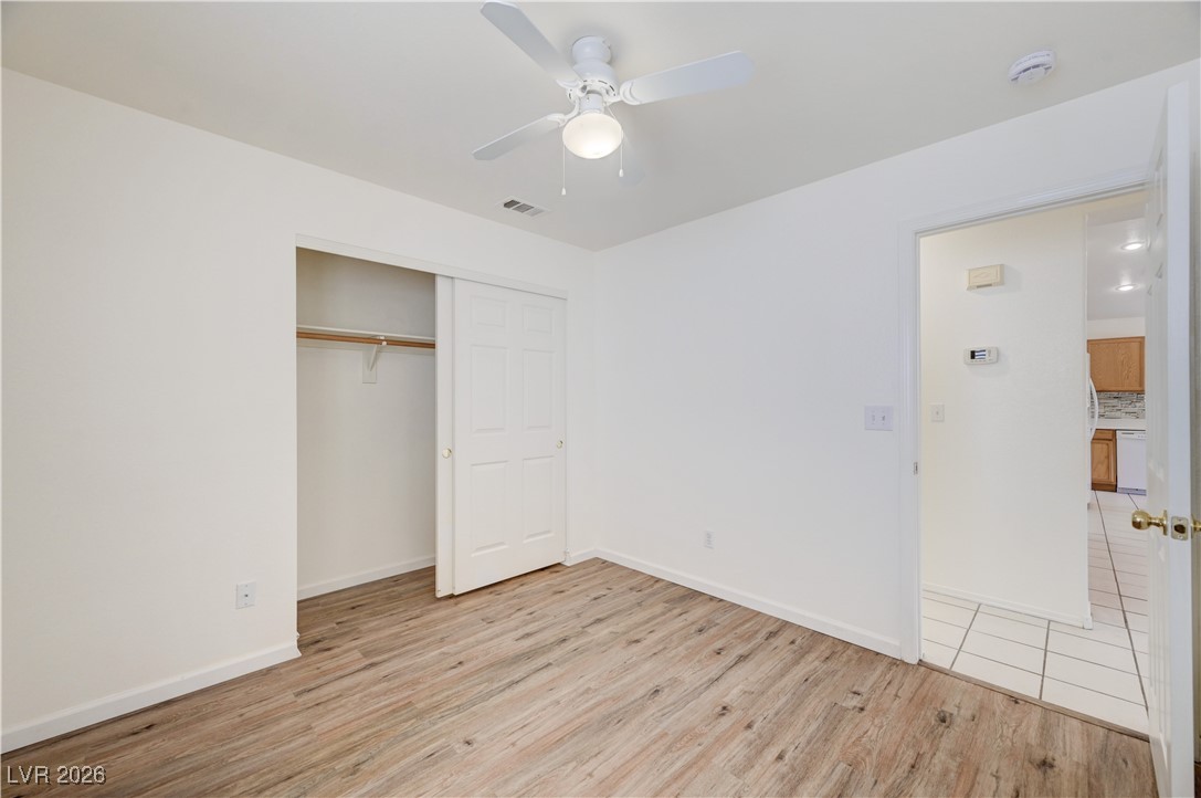 9929 Princess Cut Street Las Vegas, NV 89183 - Photo 38 of 52 Unfurnished bedroom with light wood-type flooring, a ceiling fan, and a closet