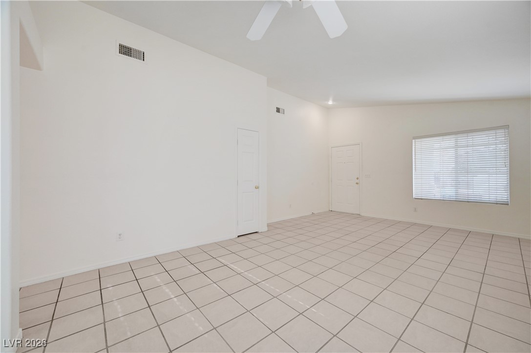 9929 Princess Cut Street Las Vegas, NV 89183 - Photo 10 of 52 Unfurnished room featuring lofted ceiling and baseboards