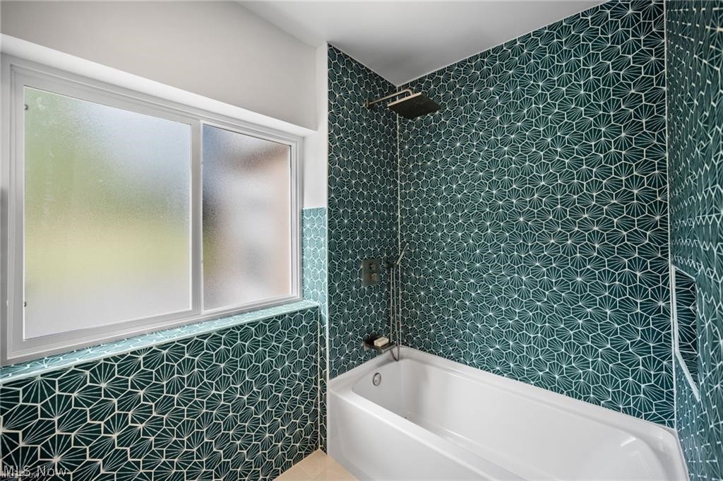 28300 Aurora Road Solon, OH 44139 - Photo 8 of 36 Bathroom featuring a deep soaking tub with a wall-mounted rain shower head