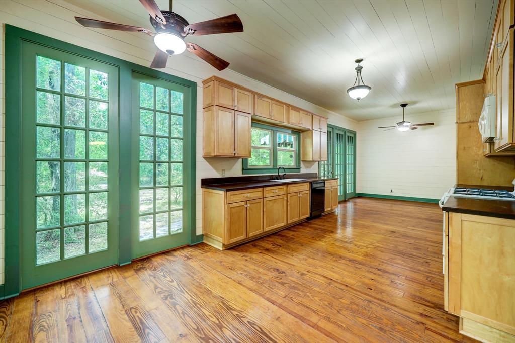 a view of a kitchen with kitchen island wooden floor and a window