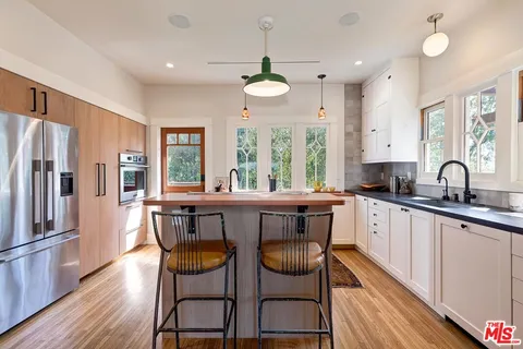 a kitchen with granite countertop a sink and cabinets