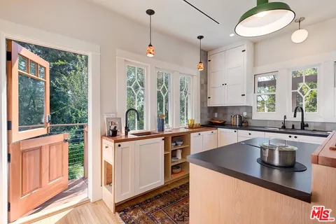 a kitchen with granite countertop a sink and a window