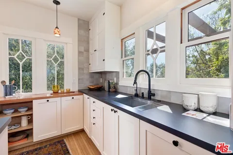 a spacious bathroom with a granite countertop sink a mirror and a shower