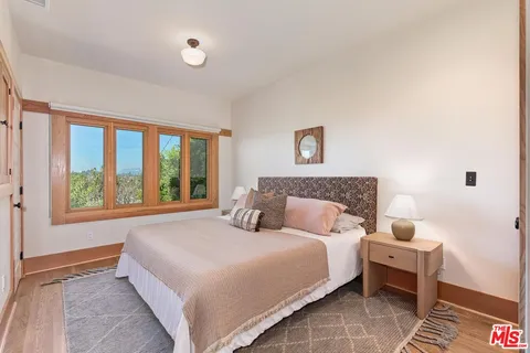a bathroom with a granite countertop sink a mirror and a shower