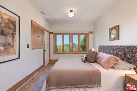 a bedroom with a bed furniture and a window