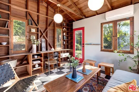 a view of a patio with chairs and potted plants