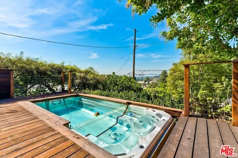 a view of a patio with couches table and chairs and potted plants