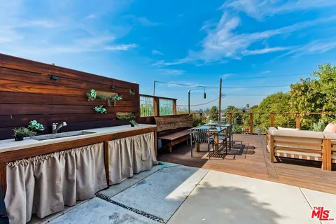 a backyard of a house with outdoor seating
