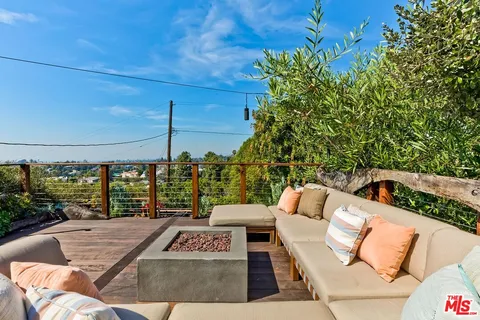 a view of backyard with seating area and trees