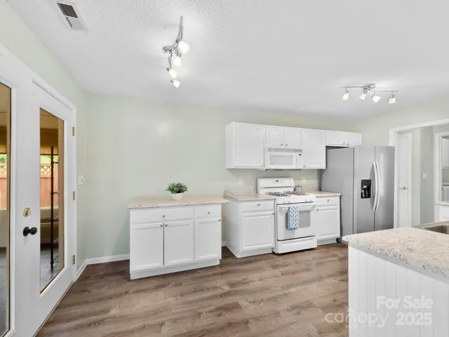 a view of a kitchen with electric appliances