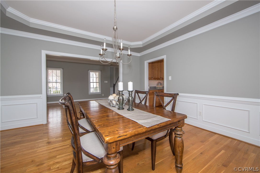 1000 Cohen Trail Midlothian, VA 23114 - Photo 16 of 41 a dining room with furniture a chandelier and wooden floor
