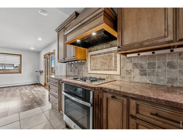 a kitchen with granite countertop a stove and a sink