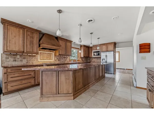 a kitchen with stainless steel appliances granite countertop a sink and cabinets