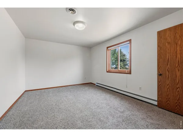 a view of an empty room with windows