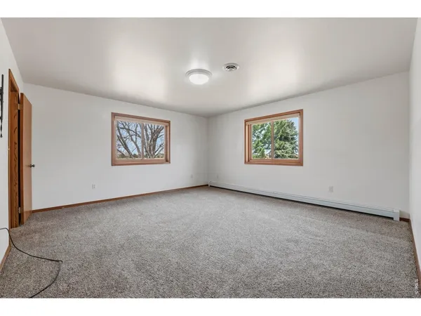 a view of an empty room with windows