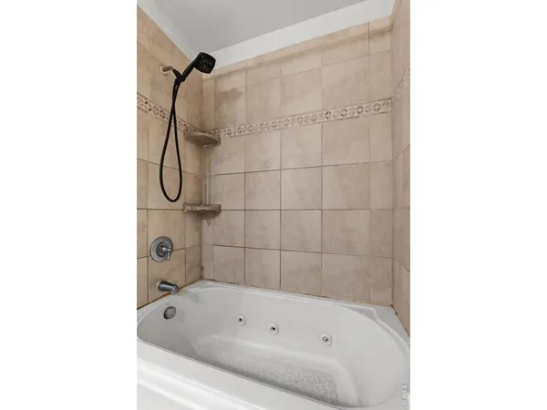 a bathroom with a bath tub with a shower
