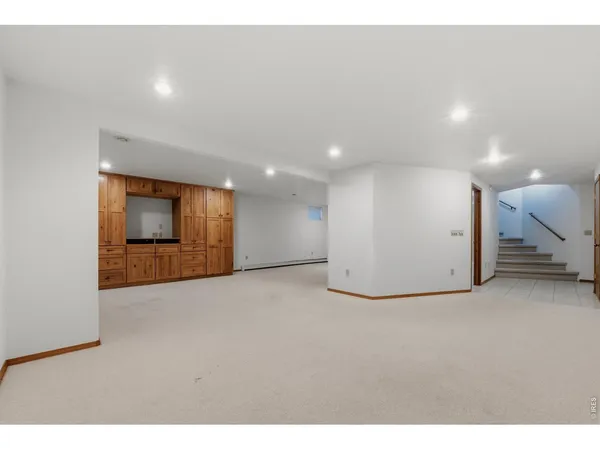 a view of an empty room with a kitchen