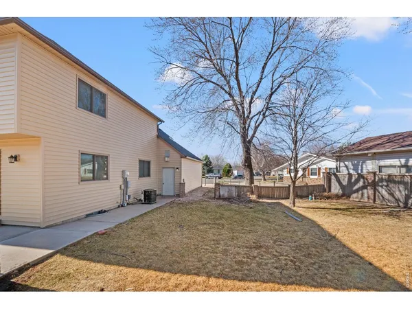 a backyard of a house with large trees