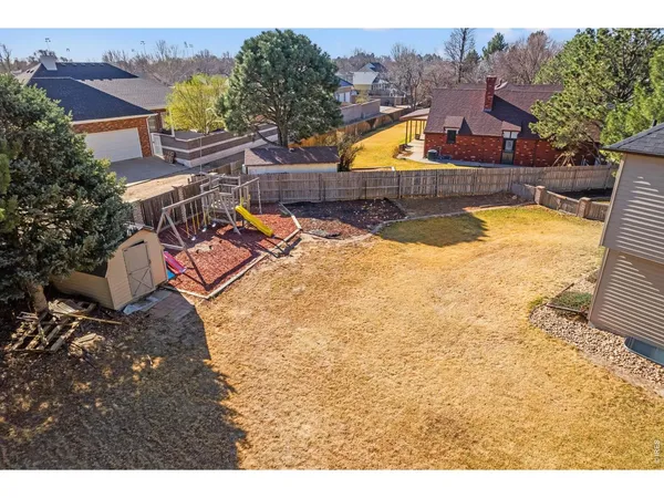 an aerial view of a house with swimming pool and big yard
