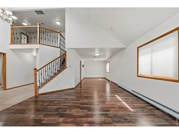 a view of an entryway with wooden floor