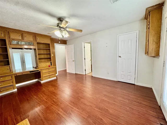 a view of walk in closet with wooden floor