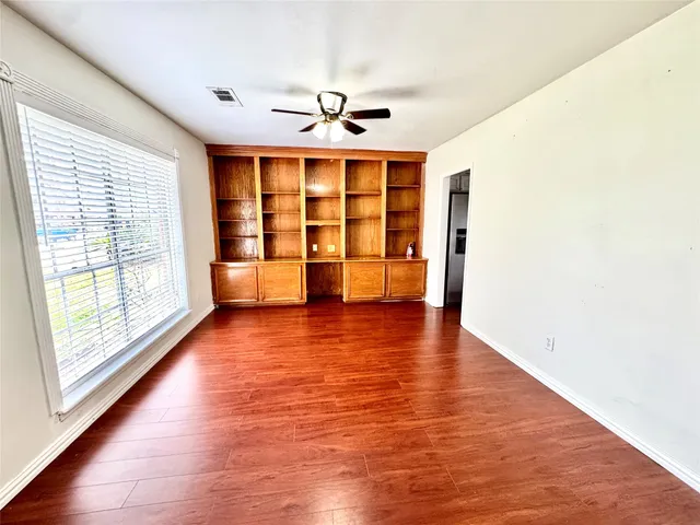 a view of a kitchen with a sink and wooden floor