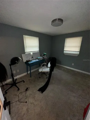 a living room with a bed and a dresser