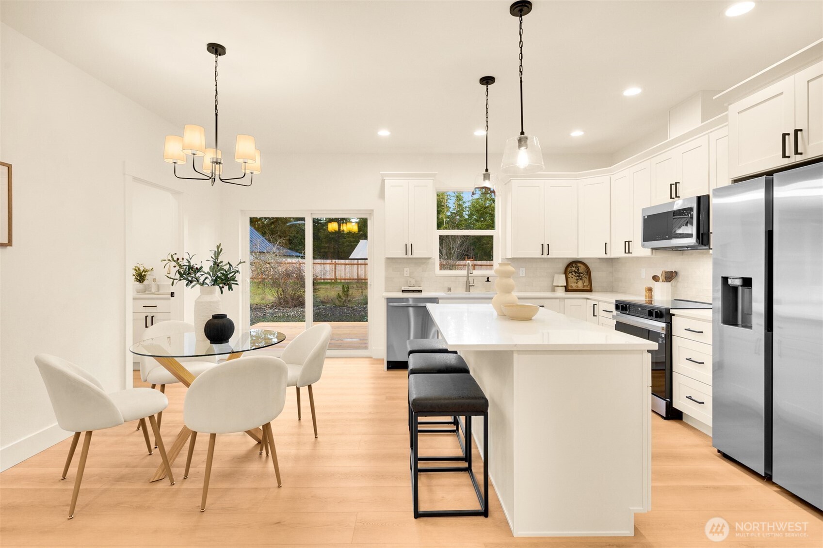 3000 West Martin Road Shelton, WA 98584 - Photo 12 of 38 a kitchen with refrigerator a stove and chairs