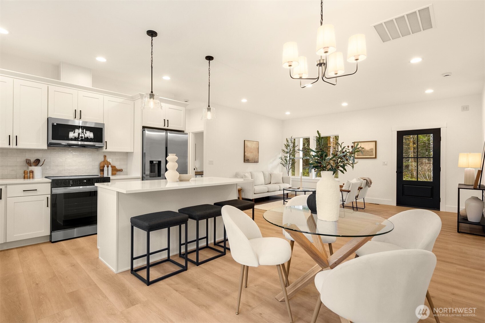 3000 West Martin Road Shelton, WA 98584 - Photo 14 of 38 a kitchen with stainless steel appliances kitchen island granite countertop a dining table chairs and sink