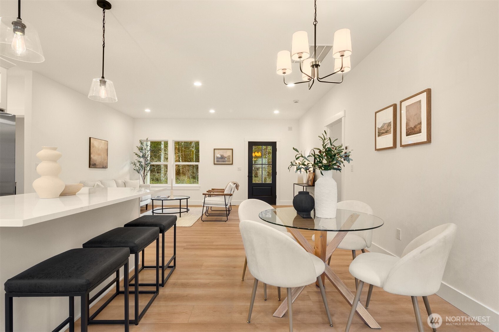 3000 West Martin Road Shelton, WA 98584 - Photo 17 of 38 a dining room with wooden floor a chandelier a wooden table and chairs