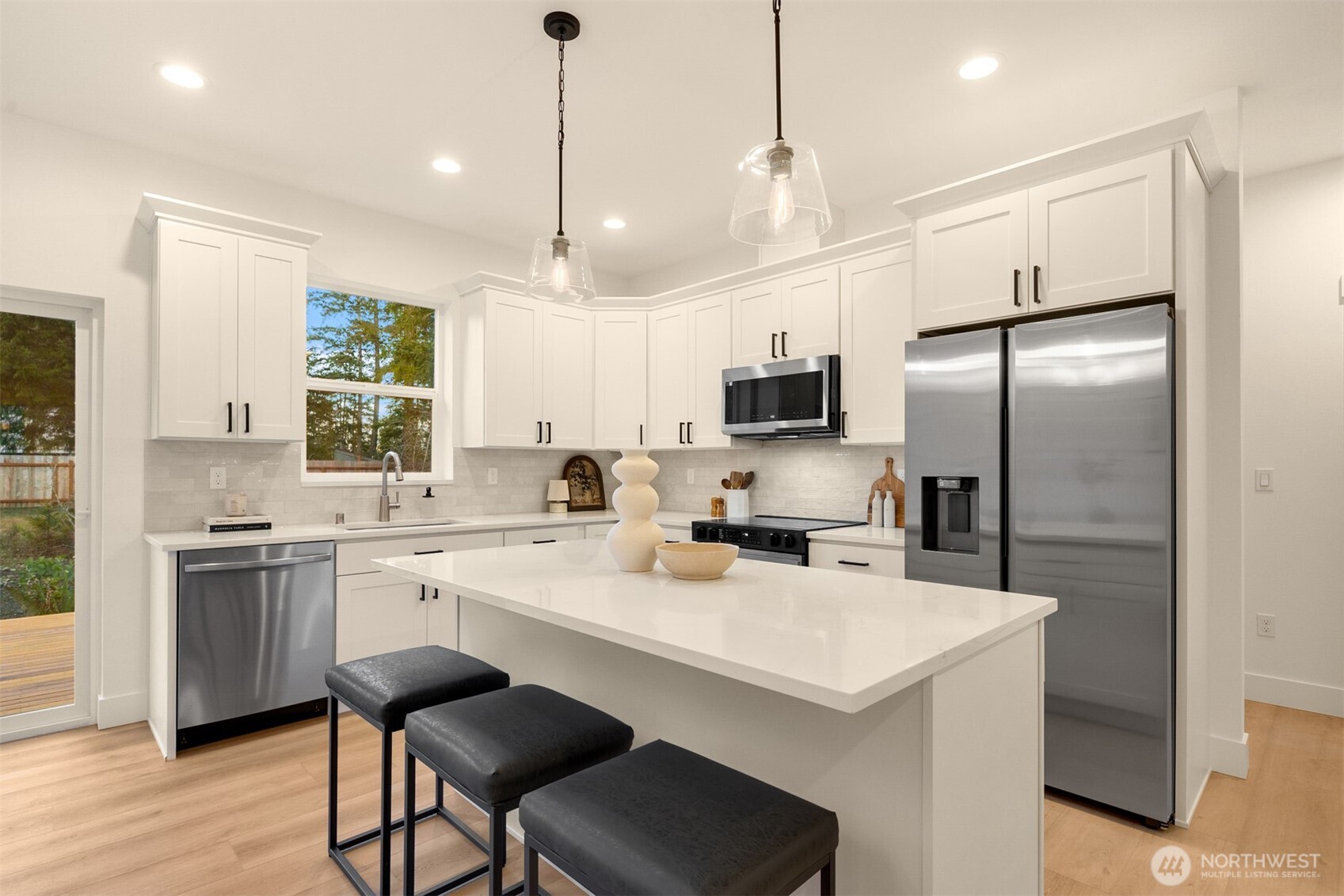 3000 West Martin Road Shelton, WA 98584 - Photo 10 of 38 a kitchen with a sink a center island a stove and a center island
