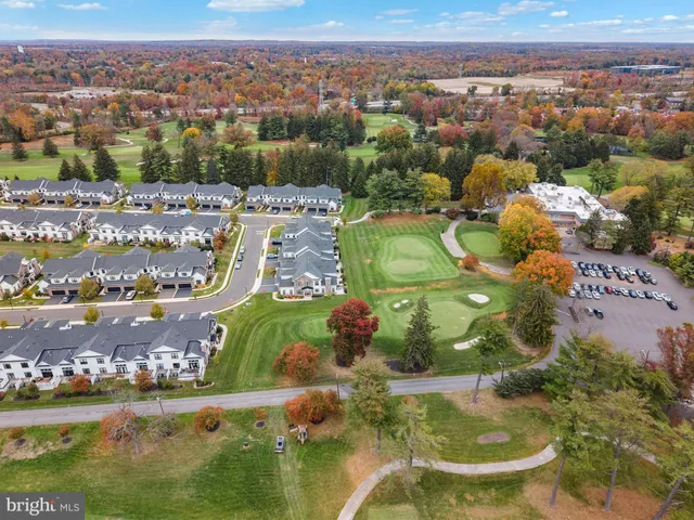 a living room with lots of furniture and a book shelf