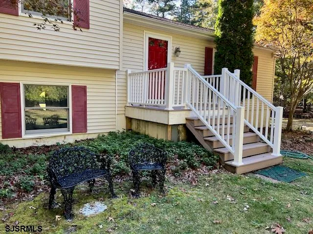 a front view of a house with porch and garden
