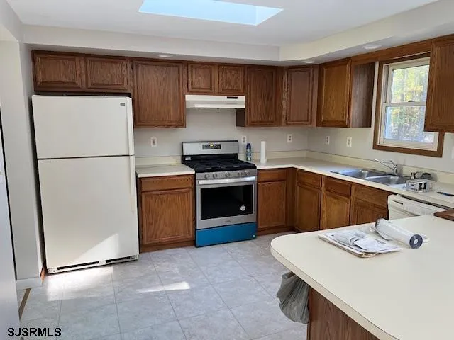 a kitchen with a stove a sink and a refrigerator