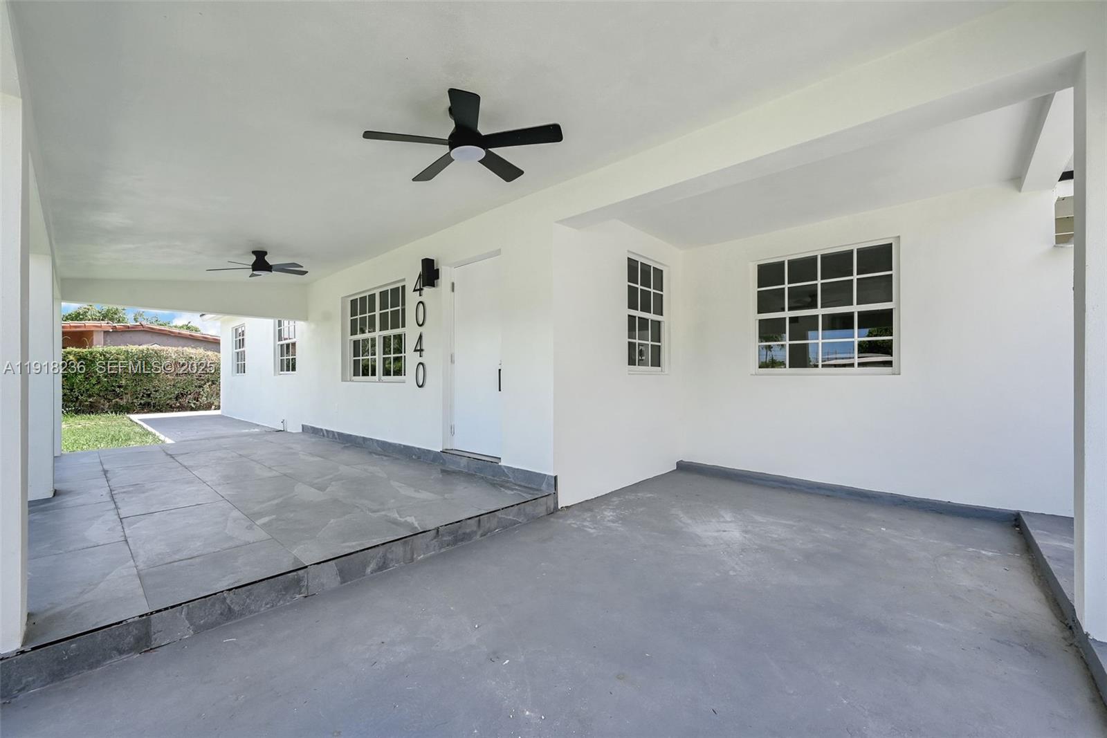 4040 Southwest 108th Avenue Miami, FL 33165 - Photo 17 of 29 a view of empty room with windows and ceiling fan view