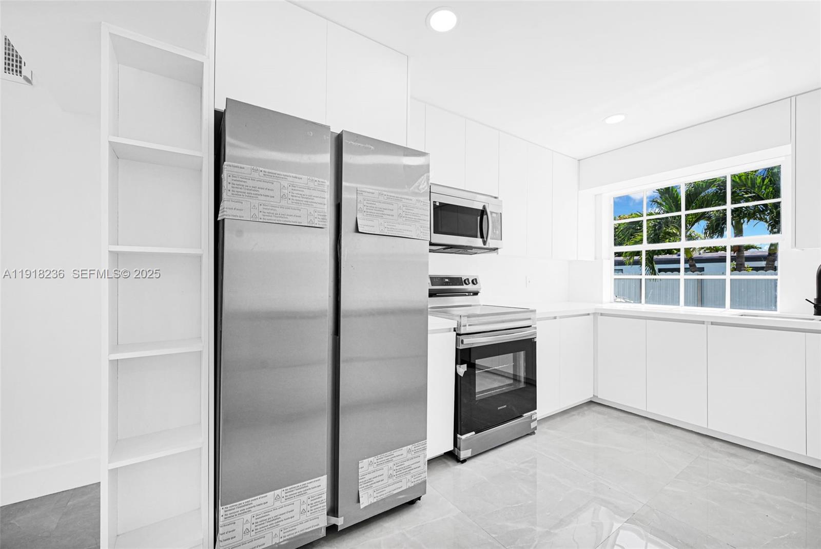 4040 Southwest 108th Avenue Miami, FL 33165 - Photo 2 of 29 a kitchen with a refrigerator and a sink