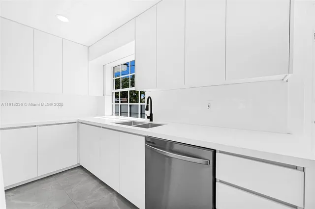 a kitchen with a white cabinets and a sink
