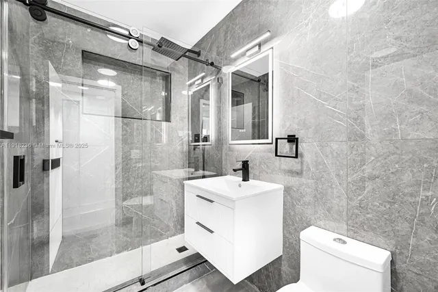 a bathroom with a sink toilet and shower