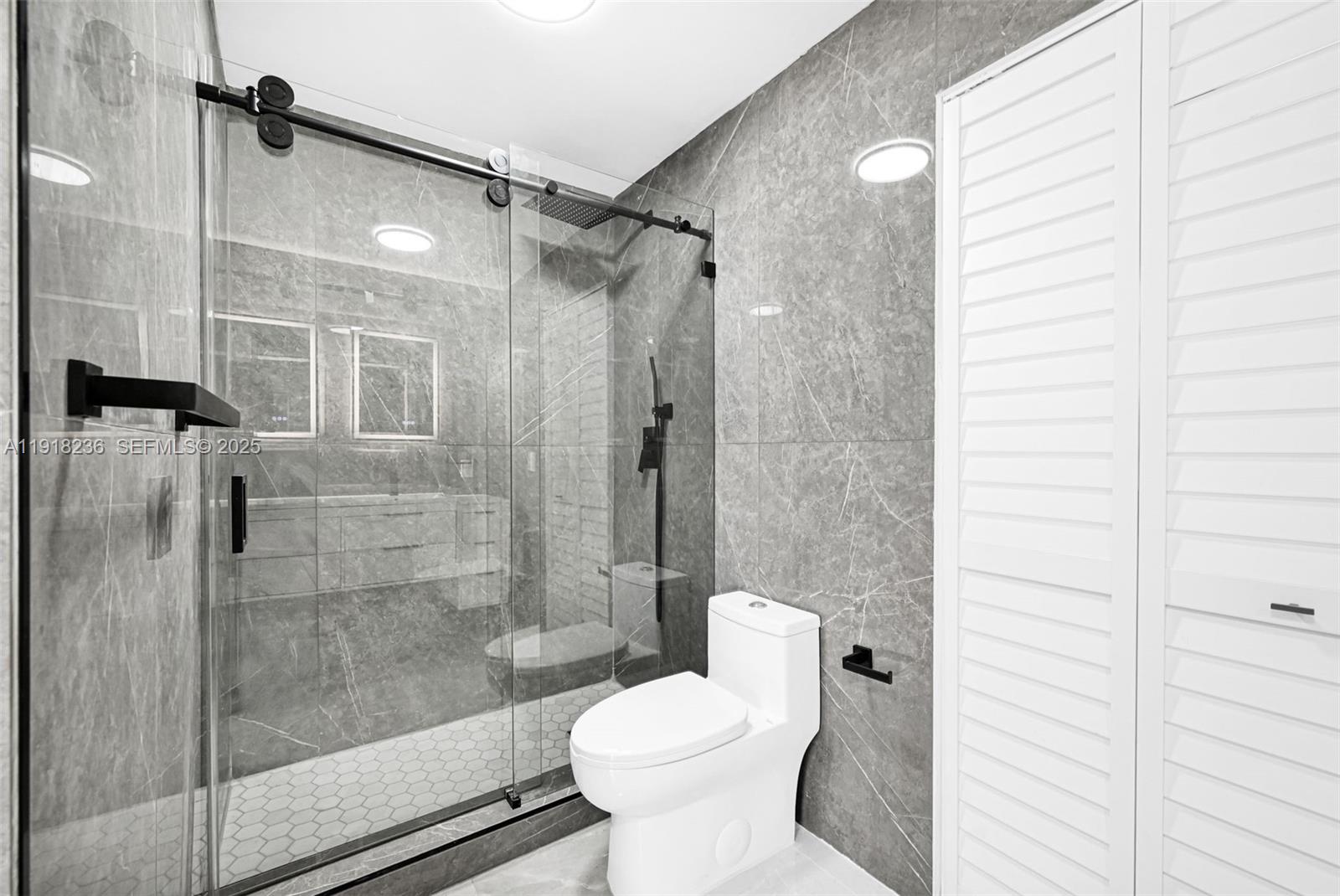 4040 Southwest 108th Avenue Miami, FL 33165 - Photo 9 of 29 a bathroom with a toilet and shower