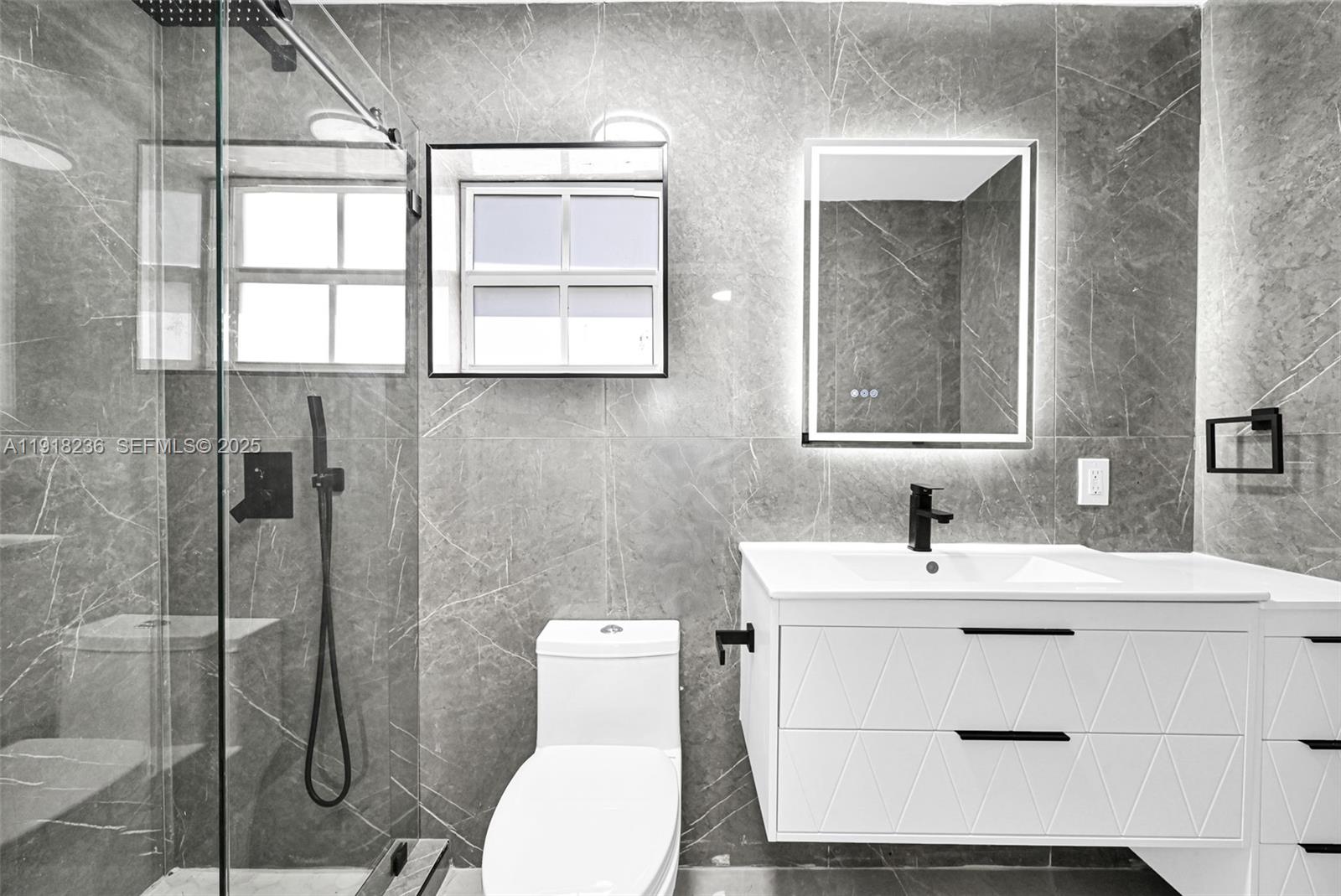 4040 Southwest 108th Avenue Miami, FL 33165 - Photo 10 of 29 a bathroom with a toilet sink vanity and mirror