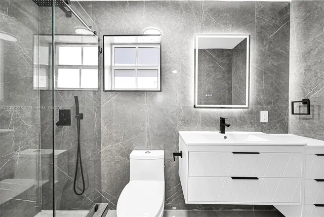 a bathroom with a sink toilet and shower