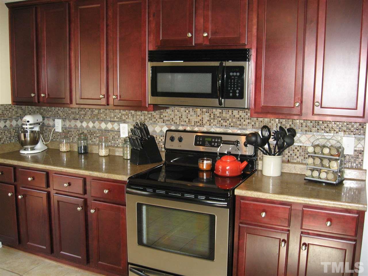 185 Libbie Road Autryville, NC 28318 - Photo 14 of 25 a kitchen with granite countertop stainless steel appliances a stove microwave and cabinets