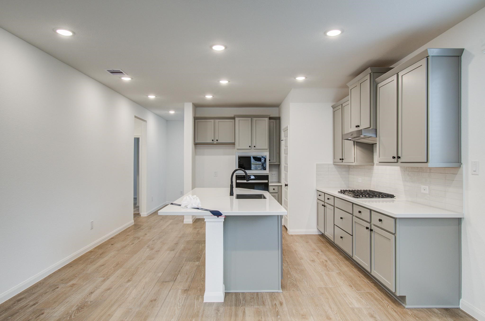7231 Yarrow Blossom Court Katy, TX 77493 - Photo 21 of 49 a kitchen with stainless steel appliances granite countertop a stove a sink and a refrigerator