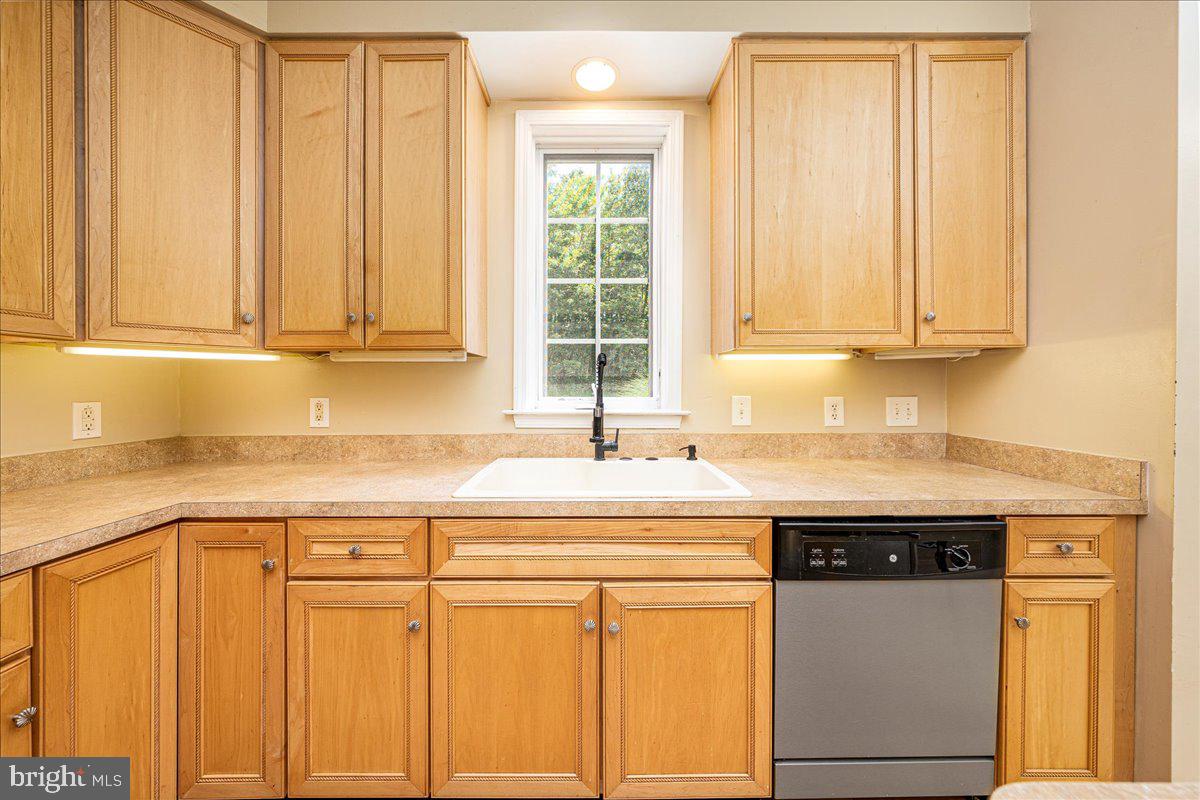 14145 Roberts Road Hancock, MD 21750 - Photo 21 of 69 a kitchen with granite countertop cabinets sink and white appliances