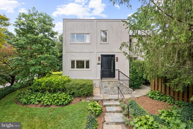 a front view of a house with a garden