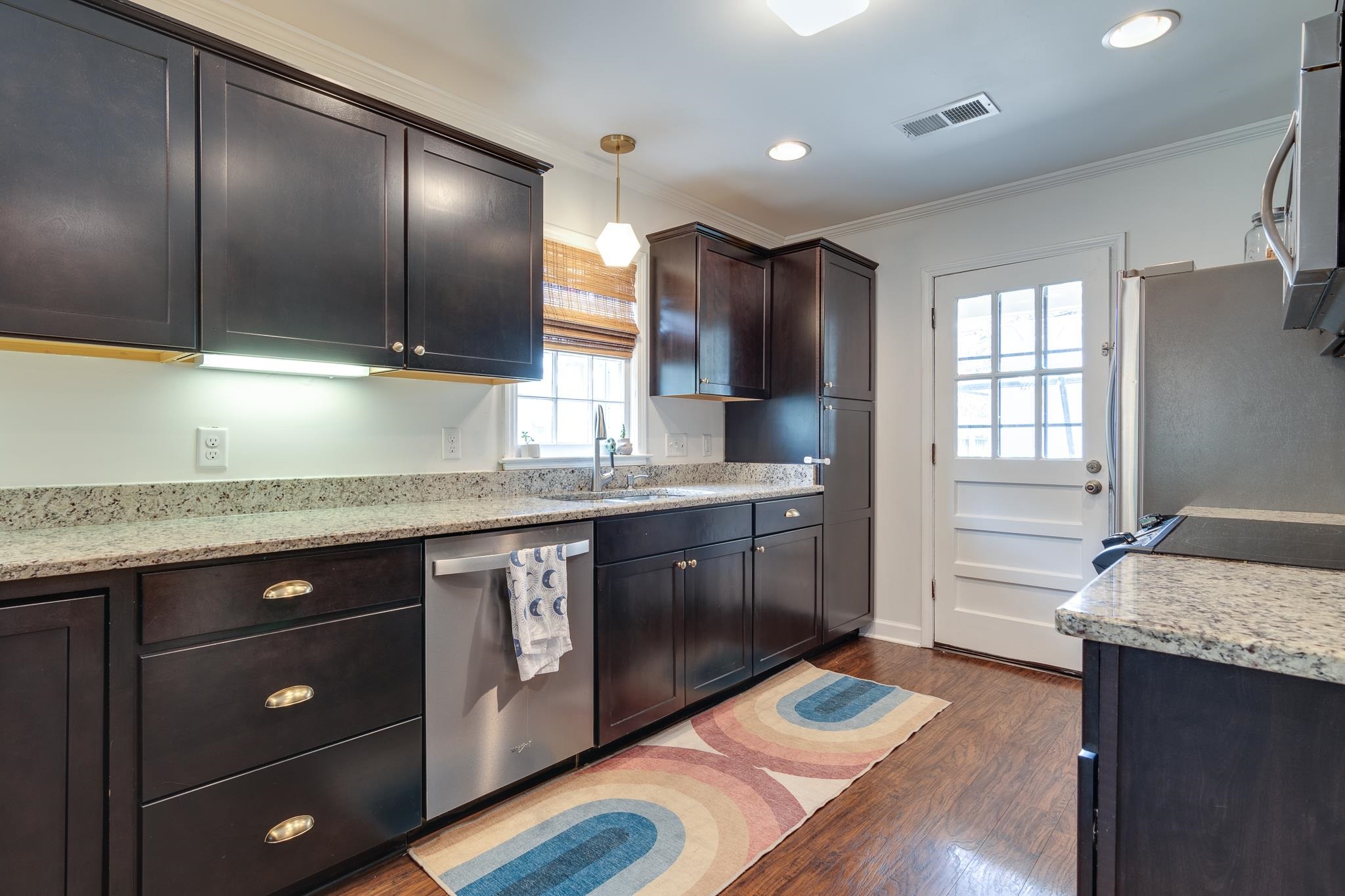5134 Helene Road Memphis, TN 38117 - Photo 8 of 25 a kitchen with stainless steel appliances granite countertop a sink stove and cabinets
