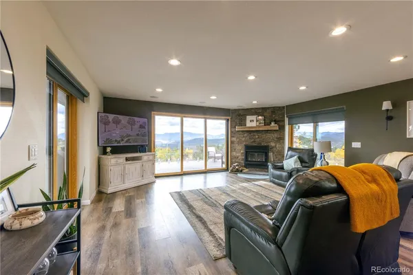 a kitchen with stainless steel appliances granite countertop a kitchen island and chairs in it
