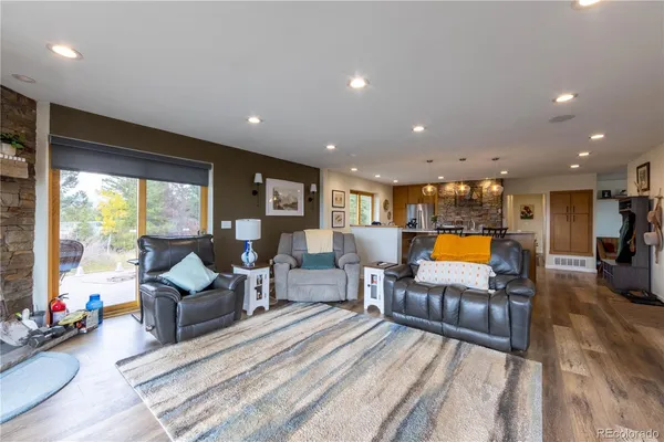 a kitchen with stainless steel appliances granite countertop a lot of counter space and wooden floors