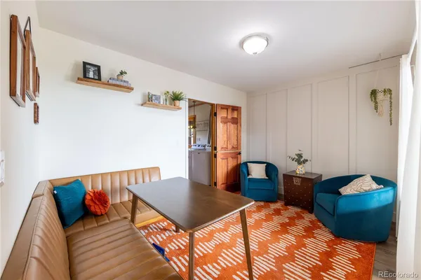 a living room with furniture and a large mirror